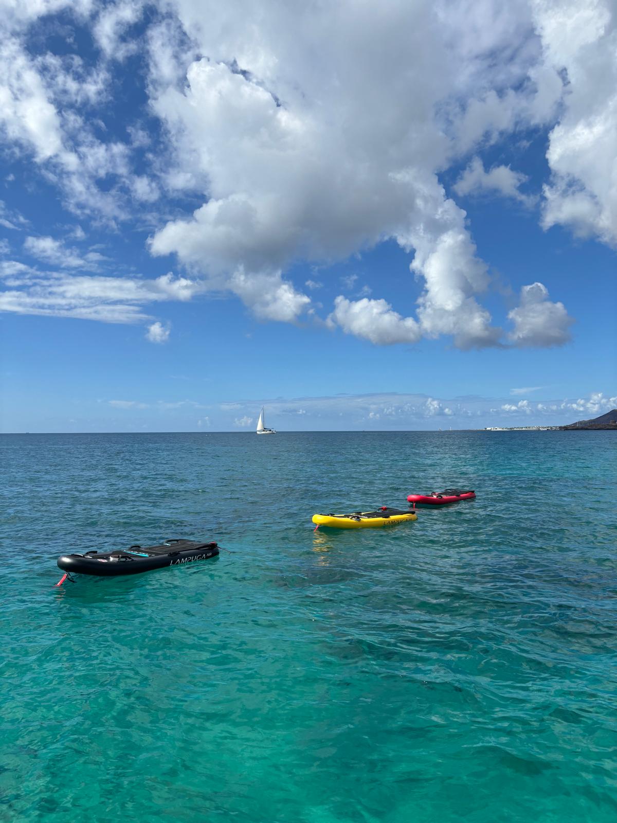 Lampuga electric surfboards on turquoise water in Playa Blanca, Lanzarote