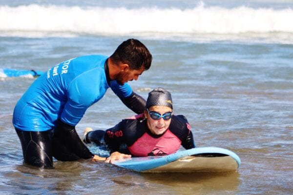 Instructor helping student in water