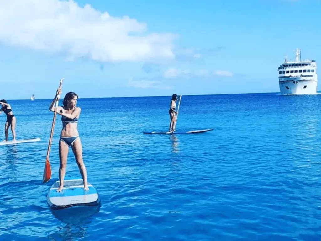 Group of stand up paddle boarders exploring Papagayo coast in Lanzarote