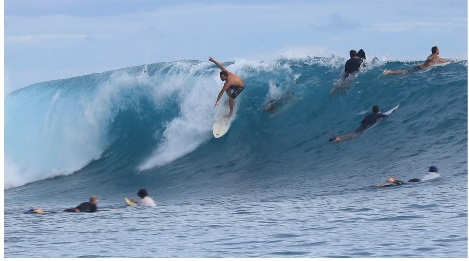 Surfer dropping in on a powerful wave at a remote Lanzarote break